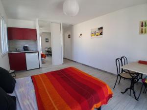 a living room with a table and a colorful blanket at Maison avec piscine in Cessenon