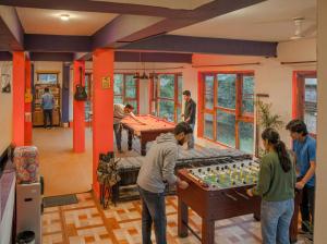 a group of people playing a game on a table at Loopin Mcleodganj in McLeod Ganj +52 photos