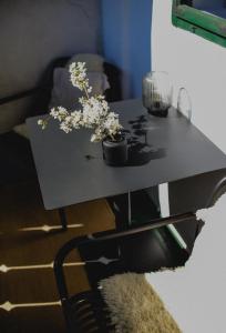 a black table with flowers on top of it at Domeček / Tiny House in Český Krumlov +69 photos