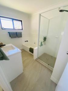 a white bathroom with a shower and a sink at Mariners Rest in Redland Bay +25 photos