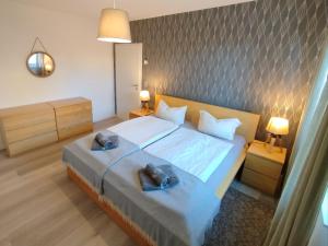 a bedroom with a large bed with two towels on it at Ferienoase Müller in Lichtenhain