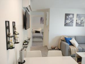 a living room with a couch and a room with a bed at Ka6 Infinity Apartment - Vipava Valley in Ajdovščina