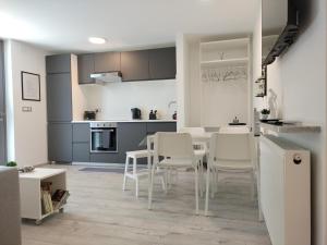 a kitchen and dining room with a table and chairs at Ka6 Infinity Apartment - Vipava Valley in Ajdovščina