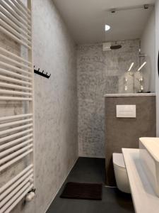 a bathroom with a white toilet and a sink at Ka6 Infinity Apartment - Vipava Valley in Ajdovščina +16 photos