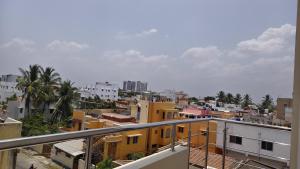 a view of a city from a balcony at Rgn Residency in Singānallūr