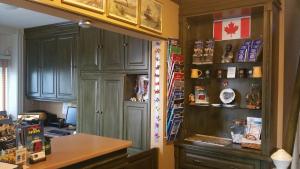 a kitchen with gray cabinets and a desk and a counter at The Inn At Lock Seven in Thorold