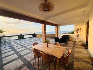 a dining room with a table and chairs at Beachfront Studio with Cozy and Spacious Balcony in Baling