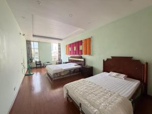 a bedroom with two beds and a large window at Hải Chiều Hotel in Ha Long
