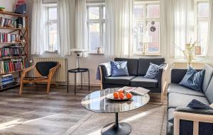a living room with a couch and a table at 4 Bedroom Awesome Home In Ribe in Ribe
