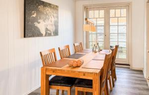 a dining room with a wooden table and chairs at 4 Bedroom Awesome Home In Ribe in Ribe