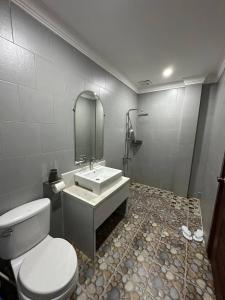 a bathroom with a toilet and a sink at The Ray Hotel & Apartments in Phnom Penh +35 photos