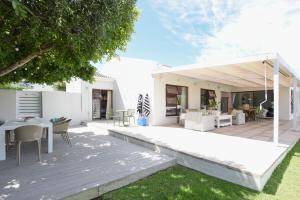 an outdoor patio with a table and chairs at Rijke Rust, Living the Lagoon Life in Langebaan