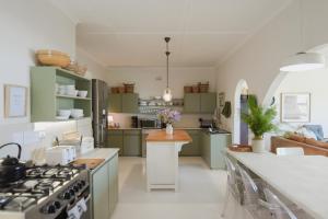 a kitchen with green cabinets and white counter tops at Rijke Rust, Living the Lagoon Life in Langebaan +60 photos