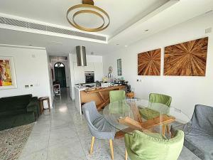 a living room with a glass table and chairs at FINELINE Villa in Limassol