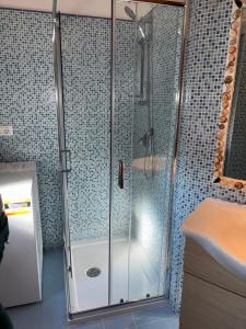 a shower with a glass door in a bathroom at Casa Dina Blu alle Morge in Torino di Sangro +34 photos