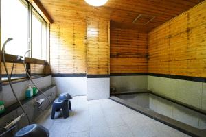 a bathroom with a tub and a toilet in it at Yamano Hidaya in Matsumoto +117 photos