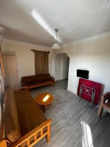 a living room with a couch and a piano at Köseoğlu Apart Villa in Fethiye
