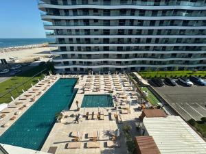 a large building with a swimming pool and a large building at Grand Panorama Residence in Mamaia