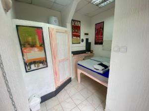 a small bedroom with a bed and a desk at Sky Stay in SJJ