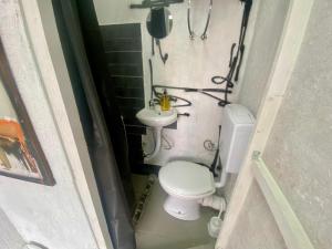 a small bathroom with a toilet and a sink at Sky Stay in SJJ