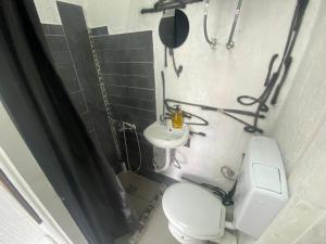 a bathroom with a toilet and a sink at Sky Stay in SJJ