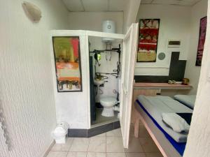 a small room with a bathroom with a toilet at Sky Stay in SJJ