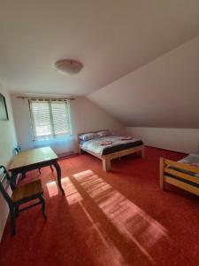 a room with two beds and a table in it at Vila Rozmital in Příbram +26 photos