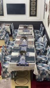 a table with blue and white chairs around it at Khiva Mahliyo in Khiva +28 photos