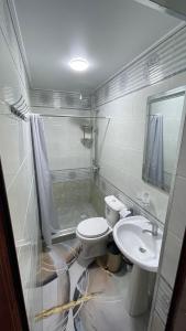 a bathroom with a toilet and a sink and a shower at Khiva Mahliyo in Khiva