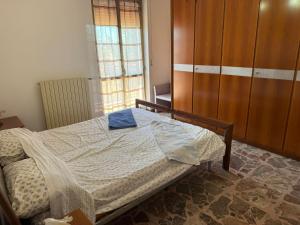 a bedroom with a bed and a large window at Villa OLGA in Ginosa Marina