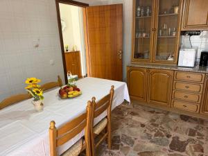 a kitchen with a table with a bowl of fruit on it at Villa OLGA in Ginosa Marina +48 photos