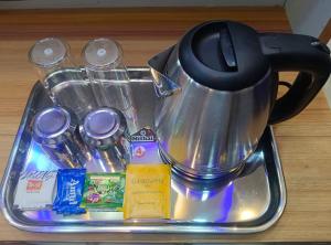 a tea pot sitting on top of a tray at Hotel Elite Walker Town in Hyderabad