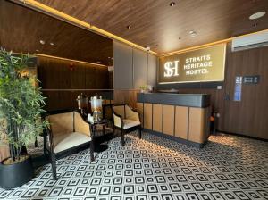 a restaurant with a table and chairs in a lobby at Straits Heritage Hostel in Singapore