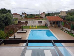a swimming pool in the backyard of a house at Villa Evenik in Eretria