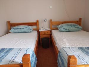 a bedroom with two twin beds and a night stand at Villa Evenik in Eretria +35 photos