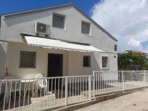a house with a white fence in front of it at Goga2 in Pirovac +2 photos