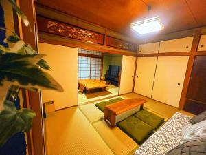a living room with a table and a couch at オリーブママのヤド 凪 バーベキュー機材レンタル可 in Shodoshima