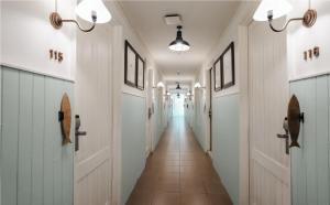 a hallway with white doors and a tile floor at Marina Express-Fisherman Aonang in Ao Nang Beach
