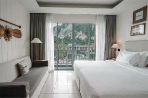 a hotel room with a large bed and a balcony at Marina Express-Fisherman Aonang in Ao Nang Beach