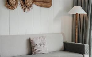 a pillow sitting on a couch next to a lamp at Marina Express-Fisherman Aonang in Ao Nang Beach