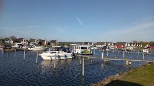 a group of boats docked in a harbor with houses at Hus 25 Wandlitz Zerpenschleuse in Wandlitz
