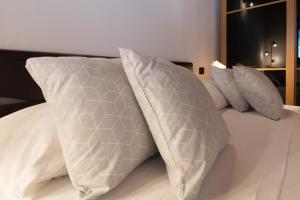 a bed with two pillows on top of it at Panorama & Pisicna Lago Endine in Ranzanico +14 photos