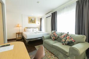 a living room with a couch and a bed at Hotel Rue De Siam in Chinatown +124 photos