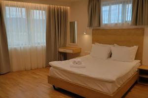 a bedroom with a bed with two towels on it at Complex SamElyon Residence in Samokov