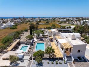 an aerial view of a villa with a swimming pool at Birds Villa Apartments with Heated Pool - Including Car and Breakfast in Perissa
