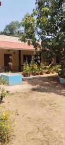a building with a lot of potted plants in a yard at AS Villa Homestay in Varkala +7 photos