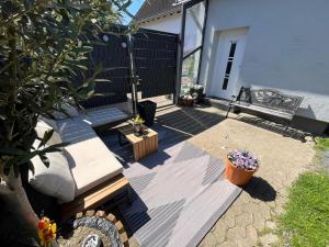 a patio with a bench and flowers in a yard at Privates Studio mit Parkplatz NAC in Euskirchen