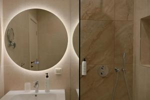 a bathroom with a sink and a mirror at Complex SamElyon Residence in Samokov