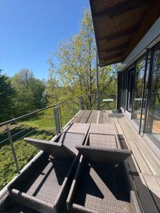 a wooden deck with a table and chairs on it at Detmolder Loft 3 in Detmold