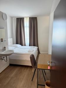 a bedroom with a bed and a sink and a table at Gästehaus E&E in Nierstein +27 photos
